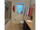 Functional bathroom with a glass door shower, toilet, and vanity sink with cabinet storage at 10148 Malpas Pt, Orlando, FL 32832