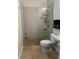 Modern bathroom featuring a tiled shower, a toilet, and a pedestal sink, designed for a clean and functional space at 10148 Malpas Pt, Orlando, FL 32832