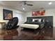 Contemporary bedroom featuring modern decor, sleek furniture, hardwood floors, and tasteful artwork at 10148 Malpas Pt, Orlando, FL 32832