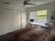 A bedroom with a computer desk next to a window and a bed featuring a leopard-print bedspread at 10148 Malpas Pt, Orlando, FL 32832