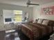 Bedroom with a comfortable bed, desk with computer, and modern decorations on the walls at 10148 Malpas Pt, Orlando, FL 32832