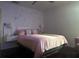 A serene bedroom with star and moon decor above a king-sized bed with elegant bedside lamps at 10148 Malpas Pt, Orlando, FL 32832