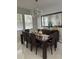 Stylish dining area with a modern table, seating for eight, and unique lighting fixture at 10148 Malpas Pt, Orlando, FL 32832