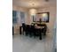 Elegant dining room with modern chandelier, large mirror, and seating for eight at 10148 Malpas Pt, Orlando, FL 32832