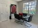 Dining area with modern table, sleek black chairs, and large windows offering views of the outdoor landscape at 10148 Malpas Pt, Orlando, FL 32832