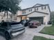 Charming two-story home with a well-manicured lawn and three car driveway at 10148 Malpas Pt, Orlando, FL 32832