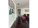 Hallway with hardwood floors, artwork displayed on the walls, and access to other rooms at 10148 Malpas Pt, Orlando, FL 32832