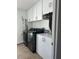 Laundry room with washer, dryer, white cabinetry and ample storage space for laundry essentials at 10148 Malpas Pt, Orlando, FL 32832