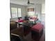 Inviting living room with comfortable seating, a ceiling fan, and large windows providing ample natural light at 10148 Malpas Pt, Orlando, FL 32832