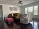 Open living area with a ceiling fan, comfortable seating, and natural light from the windows at 10148 Malpas Pt, Orlando, FL 32832
