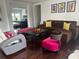 Cozy living room with hardwood floors, comfortable brown couch, and colorful accent pieces at 10148 Malpas Pt, Orlando, FL 32832