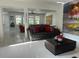 Modern living room with white tile flooring, sleek furniture, and contemporary art at 10148 Malpas Pt, Orlando, FL 32832