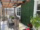 Outdoor dining space featuring a patio table, outdoor grill, and privacy wall at 10148 Malpas Pt, Orlando, FL 32832