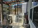 Well-equipped outdoor kitchen with grill, counter space, and outdoor dining area at 10148 Malpas Pt, Orlando, FL 32832
