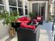 A relaxing outdoor patio with modern wicker furniture and a lush potted plant at 10148 Malpas Pt, Orlando, FL 32832