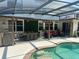 Beautiful outdoor patio area with a dining table, seating area, and pool access at 10148 Malpas Pt, Orlando, FL 32832