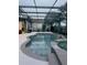 Relaxing screened-in pool and spa with waterfall feature and plenty of deck space at 10148 Malpas Pt, Orlando, FL 32832