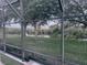 View from screened enclosure showcases water and mature trees for serene backyard at 10148 Malpas Pt, Orlando, FL 32832