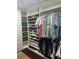 Organized walk-in closet featuring custom shelving, hanging racks, and ample storage space at 10148 Malpas Pt, Orlando, FL 32832