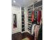 Spacious walk-in closet with custom shelving, hanging rods, and ample storage for shoes and clothing at 10148 Malpas Pt, Orlando, FL 32832