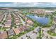 Community aerial showing a pond with a fountain, golf course and well-kept landscaping at 10203 Henbury St, Orlando, FL 32832
