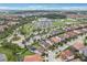 Expansive aerial view captures the community's layout, showcasing lush greenery, parking, and nearby amenities at 10203 Henbury St, Orlando, FL 32832