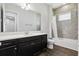 A well-lit bathroom featuring a large vanity, tiled shower and tub with neutral color palette at 10203 Henbury St, Orlando, FL 32832