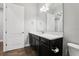 Bathroom featuring dark vanity with white countertop, chrome fixtures, and tile floors at 10203 Henbury St, Orlando, FL 32832