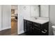 Bathroom with a white countertop vanity and modern fixtures, kitchen in background at 10203 Henbury St, Orlando, FL 32832