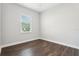 Bright room featuring dark wood floors, neutral walls, and a window that allows natural light to fill the space at 10203 Henbury St, Orlando, FL 32832