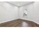 Bright room featuring dark wood floors, neutral walls, and a window that allows natural light to fill the space at 10203 Henbury St, Orlando, FL 32832