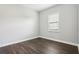 Empty bedroom features wood floors and natural light from the window at 10203 Henbury St, Orlando, FL 32832