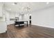 Open floor plan showcasing the dining room and kitchen with hardwood floors and modern lighting fixtures at 10203 Henbury St, Orlando, FL 32832