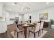 A stylish dining room featuring a dining table set for six and an open layout to the kitchen at 10203 Henbury St, Orlando, FL 32832
