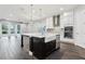 Bright eat-in kitchen with white cabinets, stainless appliances, large island, and access to the living room at 10203 Henbury St, Orlando, FL 32832