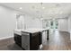Close up of the kitchen island featuring a farmhouse sink and dishwasher with the dining room in the background at 10203 Henbury St, Orlando, FL 32832