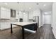 Bright, open kitchen featuring a large center island, stainless steel appliances, and white cabinetry at 10203 Henbury St, Orlando, FL 32832