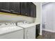 Functional laundry room features white washer and dryer and ample storage space at 10203 Henbury St, Orlando, FL 32832