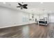Spacious living room featuring tile floors, a ceiling fan, recessed lighting, and a view of the kitchen at 10203 Henbury St, Orlando, FL 32832