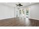 Spacious living room featuring dark hardwood flooring, ceiling fan, and sliding glass doors to outdoor patio at 10203 Henbury St, Orlando, FL 32832
