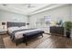 Virtually staged main bedroom boasting tray ceiling, neutral walls, and a large window at 10203 Henbury St, Orlando, FL 32832