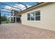 Spacious screened patio features brick flooring offering ample space for outdoor seating and entertaining at 10203 Henbury St, Orlando, FL 32832