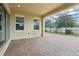 Covered patio with brick pavers, screens, and exterior windows at 10203 Henbury St, Orlando, FL 32832