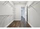 Spacious walk-in closet features wire shelving and wood-look tile flooring at 10203 Henbury St, Orlando, FL 32832