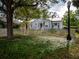 Charming single story home with a picket fence and mature landscaping at 1102 S Oak Ave, Sanford, FL 32771