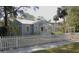 Charming cottage-style home with a white picket fence and well-maintained landscaping at 1102 S Oak Ave, Sanford, FL 32771