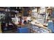 View of cluttered garage space with shelving and workbench areas, ample storage at 1102 S Oak Ave, Sanford, FL 32771