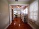 View from hallway to charming kitchen with white cabinets and stainless steel appliances at 1102 S Oak Ave, Sanford, FL 32771