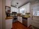 Efficient kitchen with white cabinetry, butcher block counters, and stainless steel appliances at 1102 S Oak Ave, Sanford, FL 32771