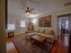 Comfortable living room with hardwood floors, a ceiling fan, and a large area rug at 1102 S Oak Ave, Sanford, FL 32771